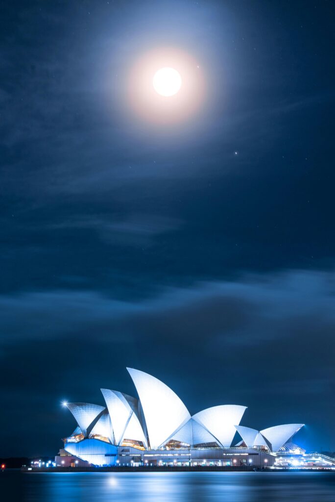 pexels-photo-2193268-2193268 Stunning view of the Sydney Opera House illuminated under a bright moonlit sky at night.